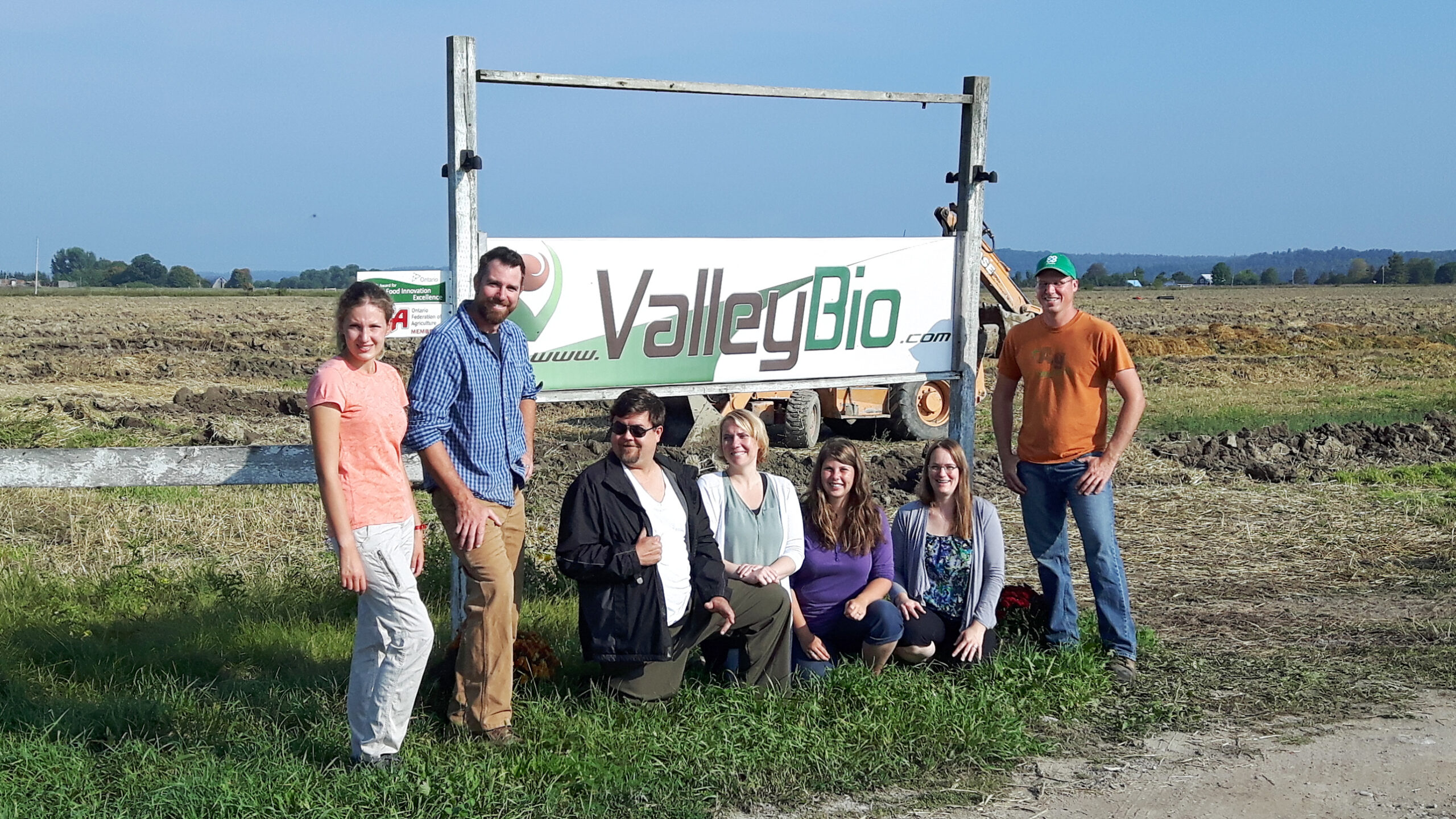 Part of the Valley Bio team poses in front of the company's sign