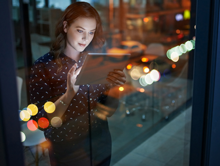 A woman works on a tablet.