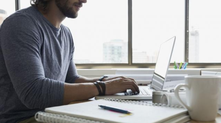 A man works at a computer.