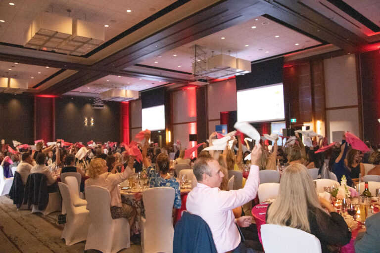 Attendees swing their napkins to the beat of music