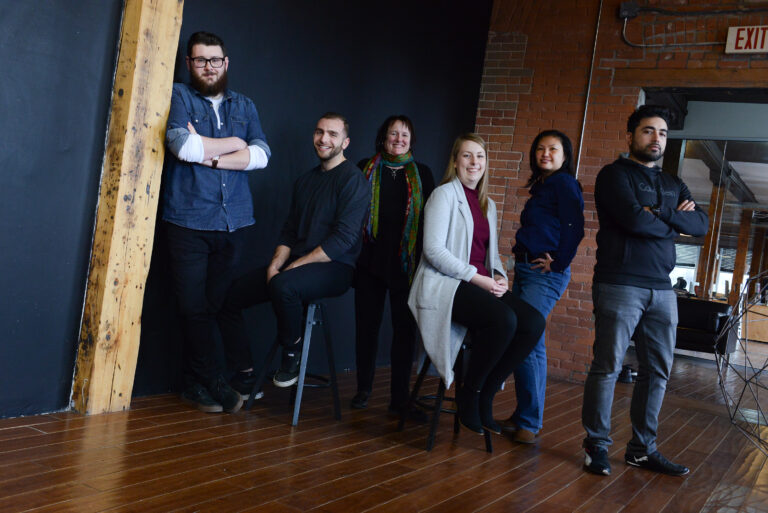 The OPIN Software web development team posts in the firm's office.