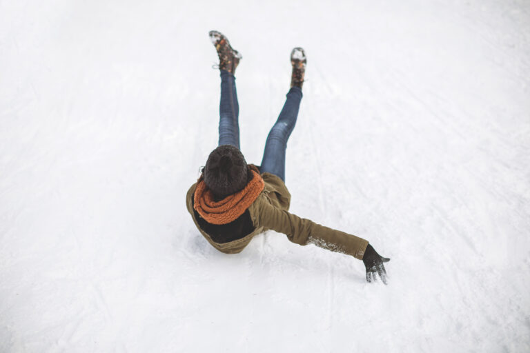 A woman slips and falls on ice