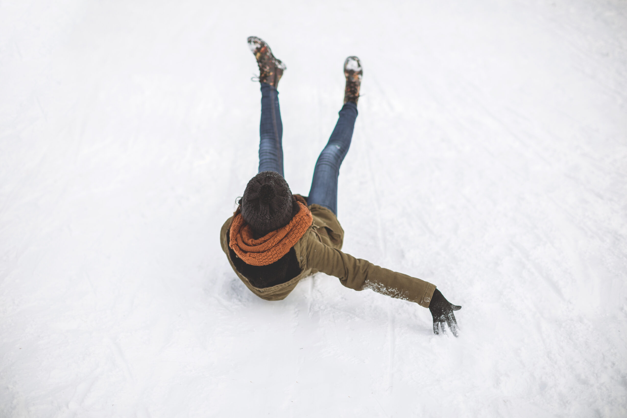 A woman slips and falls on ice