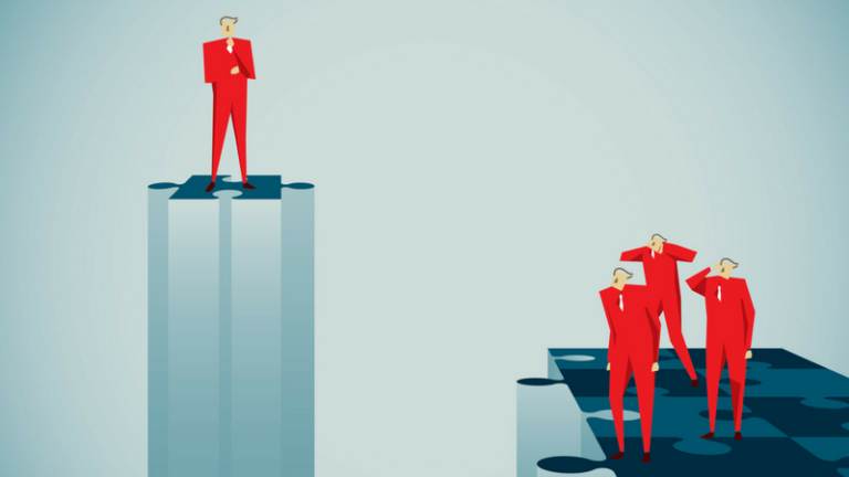 A man in a suit is raised above a crowd of his colleagues on a platform shaped like a puzzle piece.