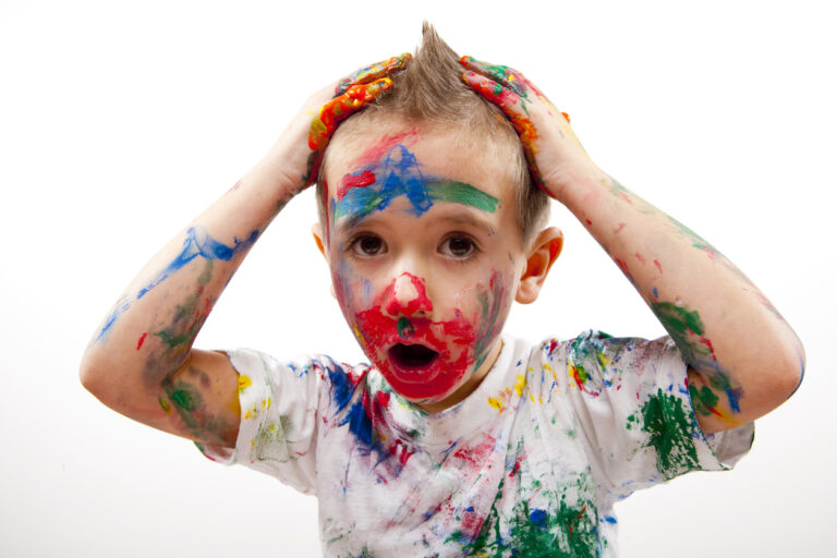A child covered in paint.