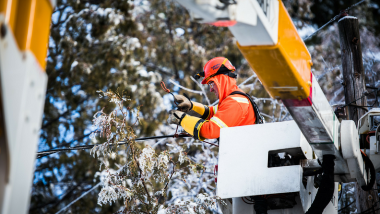 A Hydro Ottawa lineman fixing a line