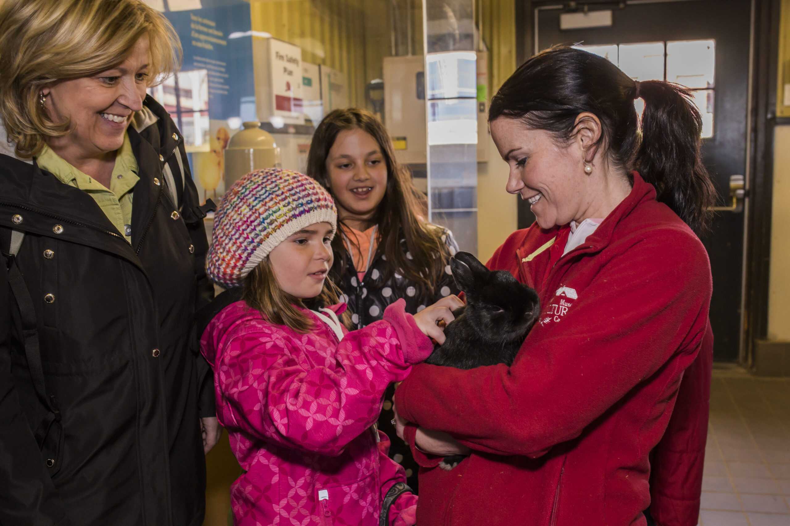 A family meets a rabbit at the Canadian Agriculture and Food Museum.