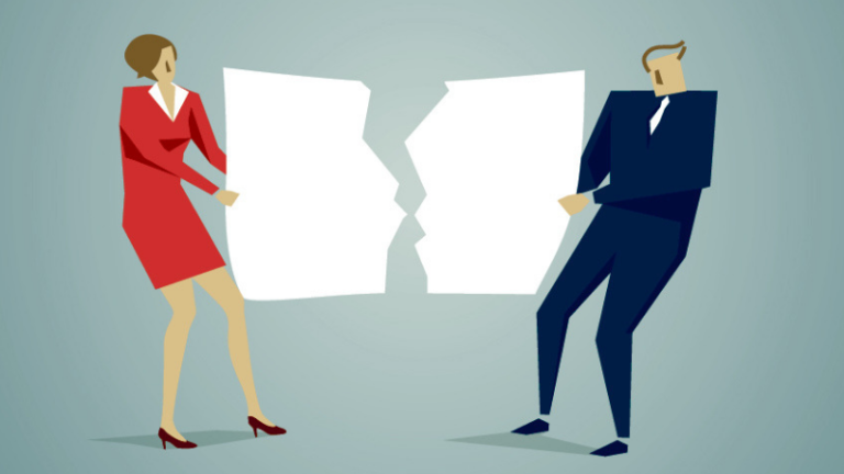 Two businesspeople tear a large piece of paper in half