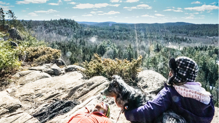 A couple and their dog sit at Eagle's Nest in Calabogie
