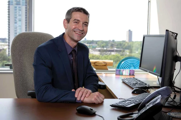 Portrait of a man sitting at his desk