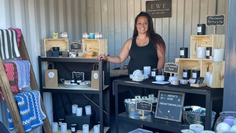 Alexis Sapera smiling among her crafts for sale