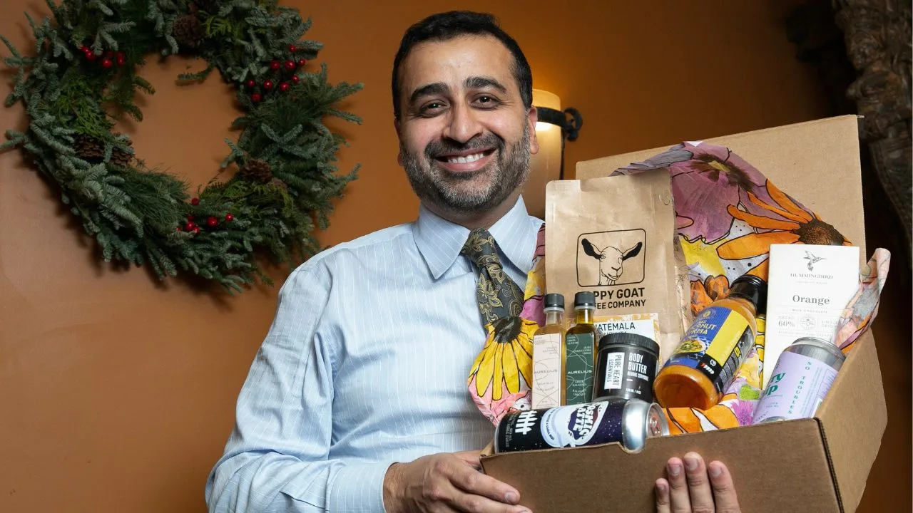 photo of a man holding a gift box of goods