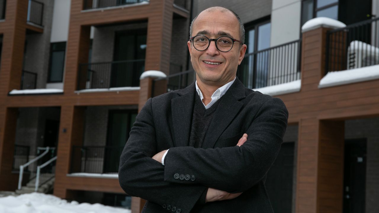 A man standing in front of newly built condos
