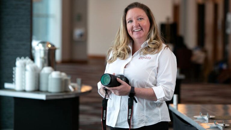 Portrait of a woman holding a camera