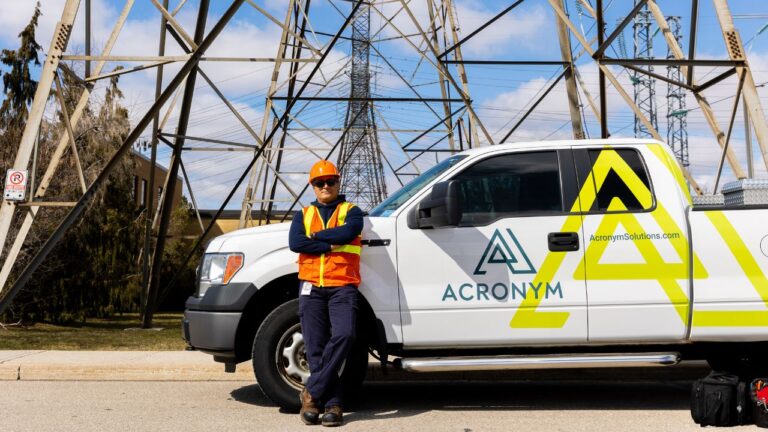 A telecommunications worker in front of a truck