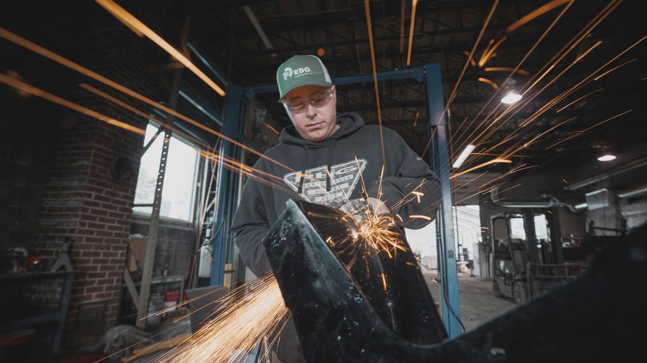 sparks fly as a man welds in smiths falls