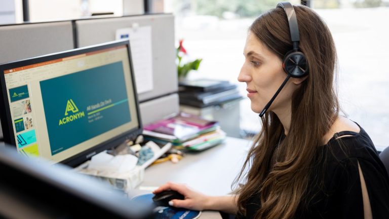 Image of an Acronym Solutions' communication team member using voice system