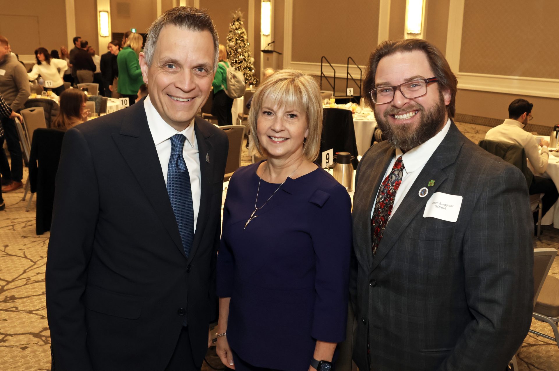 From left, Mayor Mark Sutcliffe with Joanne Read, executive vice-president and chief planning and development officer at The Ottawa Hospital, and Greater Ottawa Home Builders' Association executive director Jason Burggraaf at Infinity Convention Centre on Thursday, January 11, 2024, for the GOHBA January Breakfast. Photo by Caroline Phillips