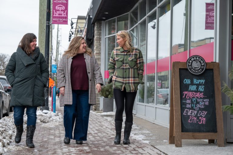 Jacqui Okum, Judy Lincoln, and Kate Laird of the Westboro Village BIA walk down the street