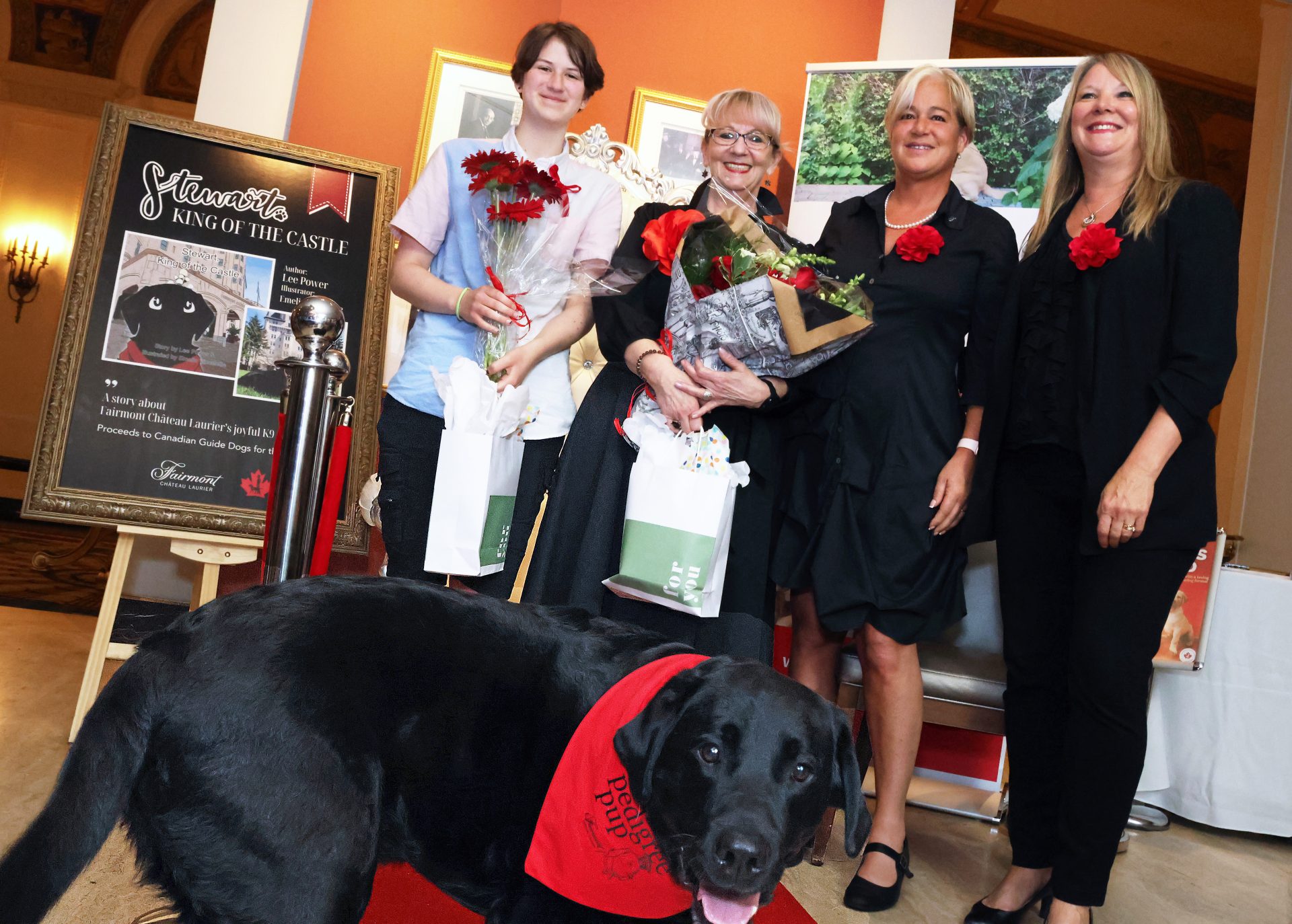 Canine ambassador Stewart (front) is the focus of a new children's book, launched Friday, June 28, 2024, at the Fairmont Château Laurier with, from left, illustrator Emelia Vincelette, hotel employee and author Lee Power, Fairmont Château Laurier general manager Geneviève Dumas and director of sales and marketing Lori Wagner. Photo by Caroline Phillips