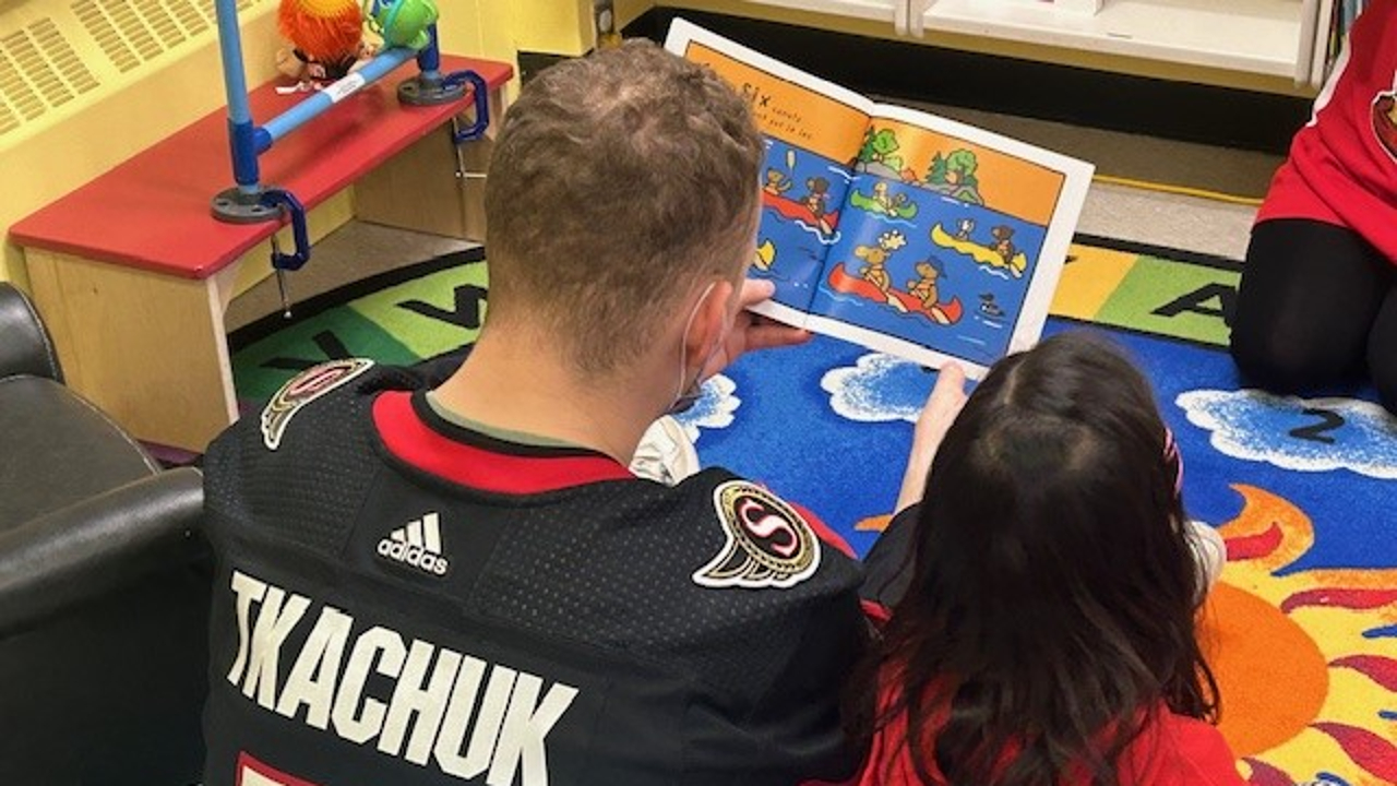Brady Tkachuk, captain of the Ottawa Senators, reading with a child at the CHEO hospital. Photo provided.