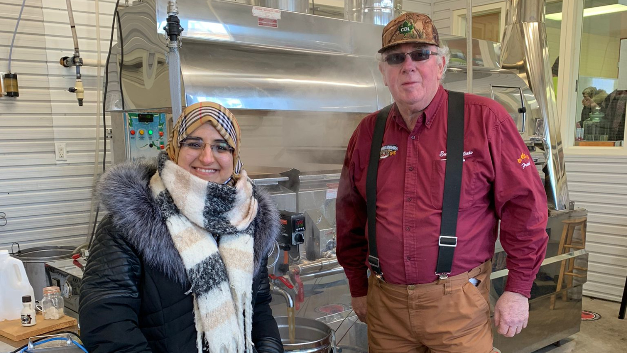 Shahad Abdulmawjood, left, visiting owner Frank Heerkens at Kemptville Campus maple syrup. Photo provided by Shahad Abdulmawjood.