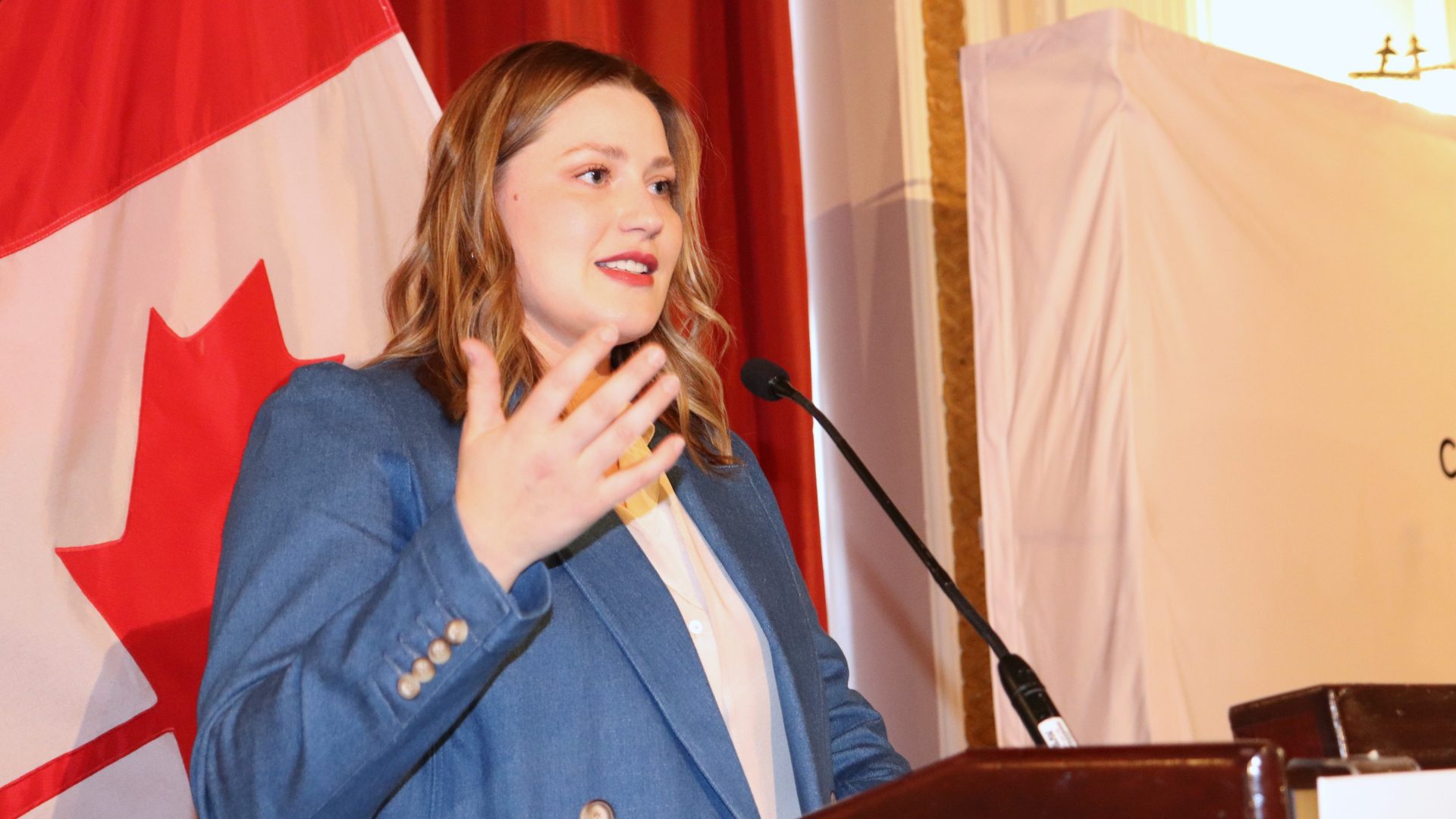 Kyla Ronellenfitsch, founder of Relay Strategies, speaks at the International Women's Day luncheon hosted by the Canadian Club on Ottawa. Photo by Mia Jensen