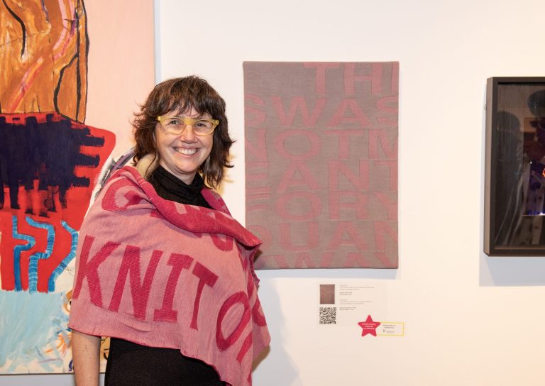 Artist Greta Grip with her piece, winner of the critics choice award, at the Ottawa Art Gallery Paint the Town Pink art auction May 29, 2025 at the OAG. Photo by Tia MacPherson.