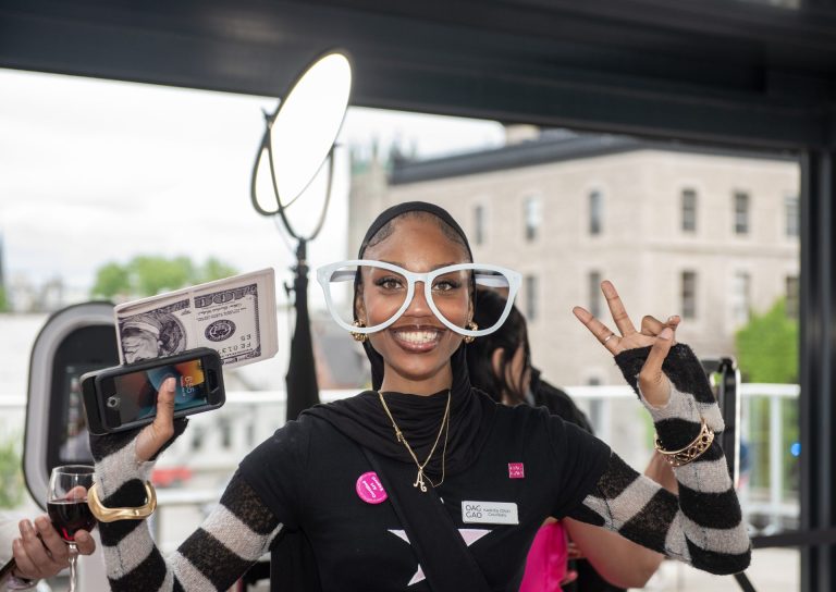 Kadidia Coulibaly from the OAG venue coordination team having fun at the 360 PhotoBooth on the patio at the Ottawa Art Gallery Paint the Town Pink art auction May 29, 2025 at the OAG. Photo by Tia MacPherson.