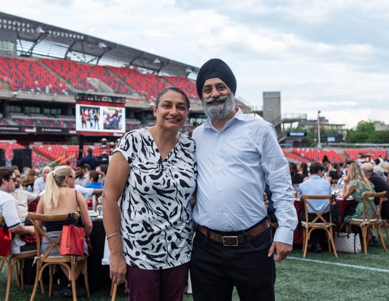 Maher Markabi and husband Taimoor Aslam share the support their son has received through the program Autism Moves at Gourmet on the Gridiron, June 24, 2025. Photo by Tia MacPherson.
