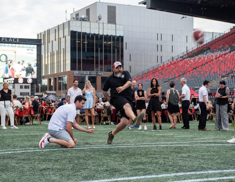 Try kicking a field goal, Marc Champagne, director of Tournaments Orléans Softball, at Gourmet on the Gridiron, June 24, 2025. Photo by Tia MacPherson.