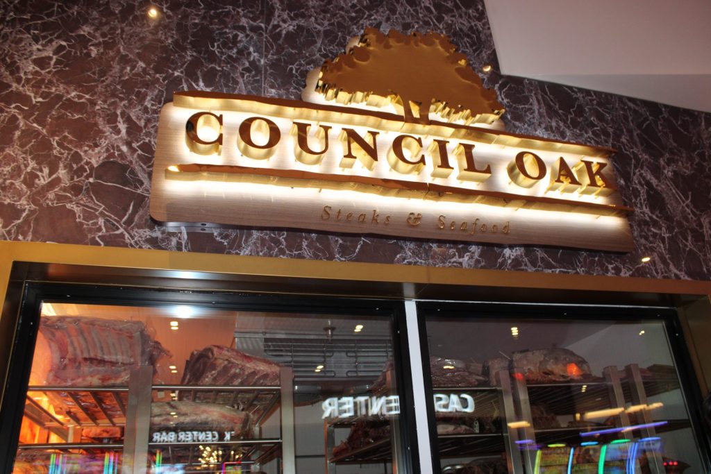The Council Oak Steaks & Seafood is the location’s signature dining location. A butcher cuts dry-aged beef displayed at the front of the restaurant. Photo by Marissa Galko.