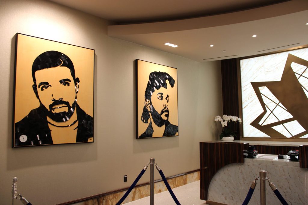Vinyl artist portraits made by Canadian artist Rob Ubels at the Hard Rock Hotel check-in desk. Photo by Marissa Galko.