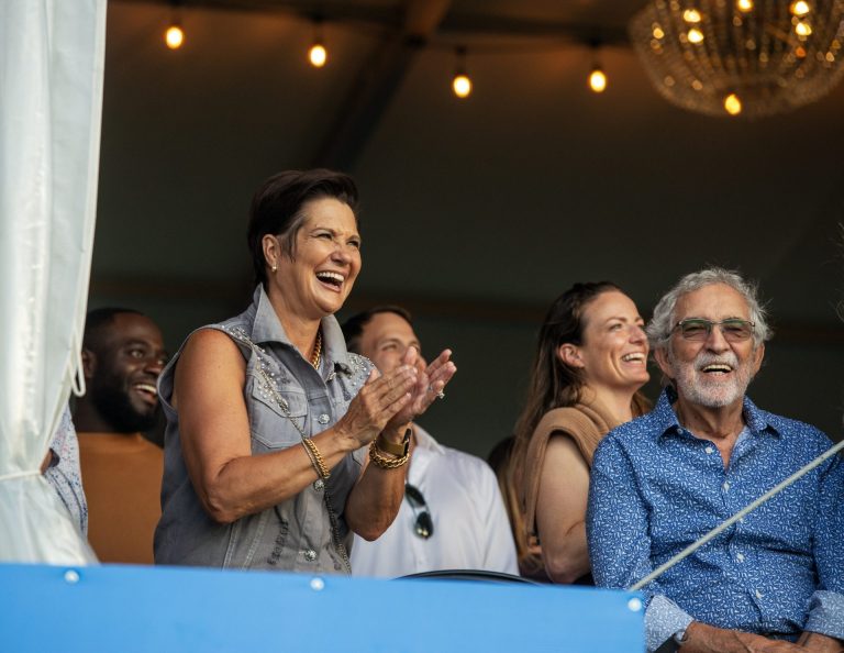 Catherine McLaughlin, Spurs & Sparkles co-chair, cheering the teams on from the stands, Spurs & Sparkles for QCH Foundation at Wesley Clover Park, August 13, 2025. Photo by Tia MacPherson.