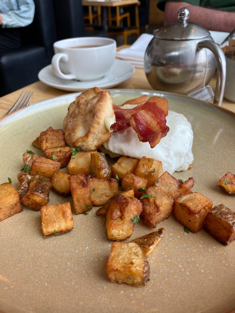 Gezellig’s breakfast sandwich features a fried egg, a buttermilk biscuit, gruyere, garlic aioli and smoked bacon. Photo by Laura Byrne Paquet.
