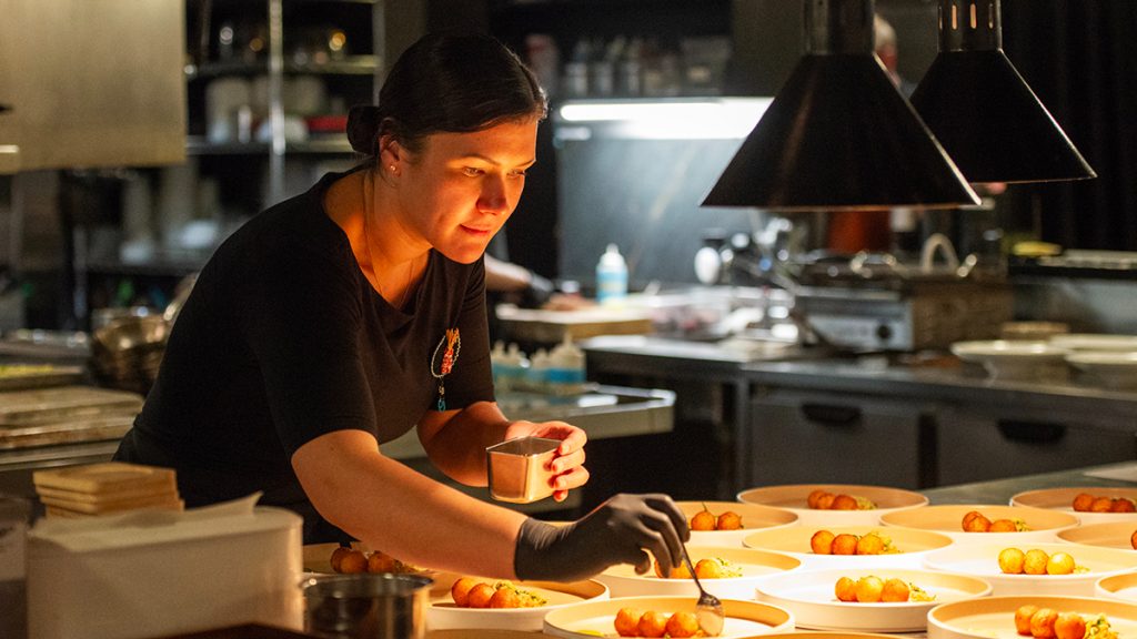 Chef Anna Cote of Kitigan Zibi Anishinaabeg plating with perfection, at Aiana Annual Reconciliation Dinner, September 23rd, 2025.