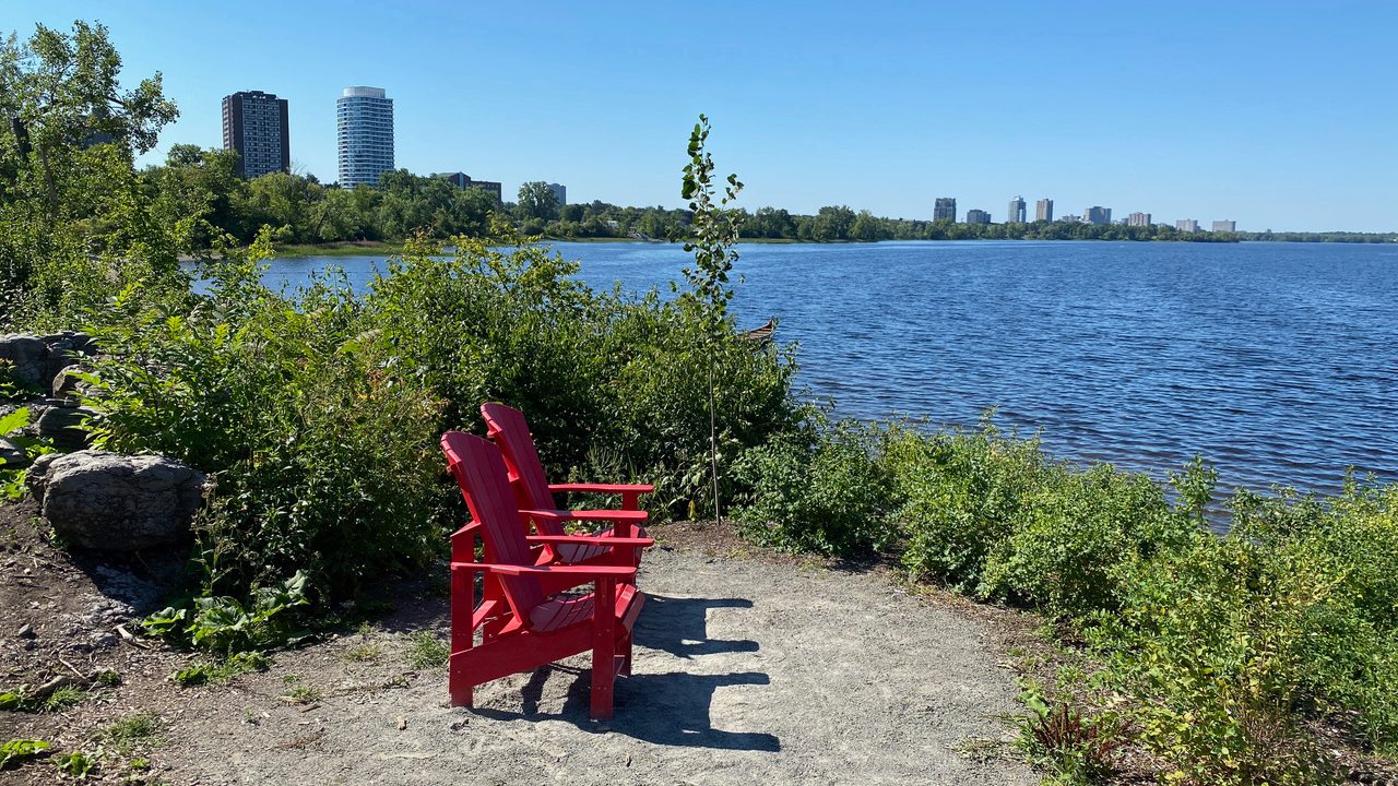 Red Muskoka chairs are a pleasant place to enjoy the view at Westboro Beach. Photo by Laura Byrne Paquet.