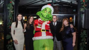 Sarah Langham (SOGH), Emma Bernans (SOGH), John Peters (Gowling WLG and Governance Committee/Honorary Officer Emeritus of Shepherds of Good Hope and Meighan Hartley (SOGH) posing with the Grinch at SOGH Foundation Ginch Dinner, Harmon’s Steak House, Nov 27, 2025. Photo by Tia MacPherson for OBJ.