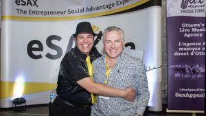 Founder of eSAX Jarrod Goldsmith with MC Dylan Black at eSAX (The Entrepreneur Social Advantage Experience)! at the Horticulture Building in Lansdowne Park, November 12th, 2025. Photo Tia MacPherson for OBJ.