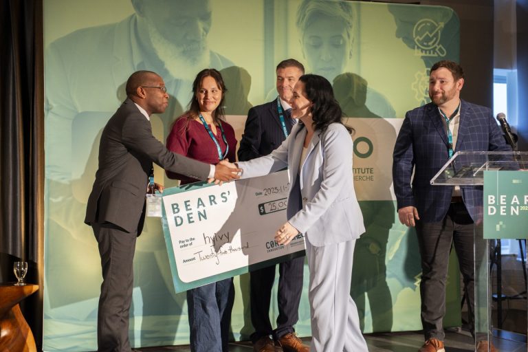 Hyivy founder and CEO Rachel Bartholomew (middle) accepts a cheque following her company's win at the 2025 Bears' Den pitch competition. Photo credit: CHEO Research Institute