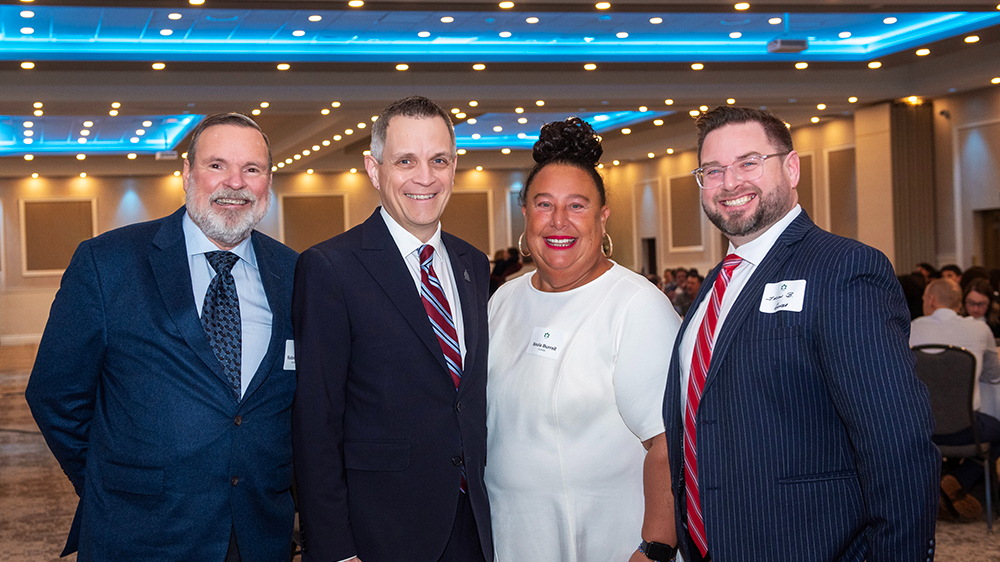 Robert Merkley (Merkley Building Supply Ltd.), Mayor Mark Sutcliffe, Soula Burrell (GOHBA) and Jason Burggraaf (GOHBA) at GOHBA Breakfast with the Mayor, Saint Elias Banquet Centre, Jan 8, 2026.