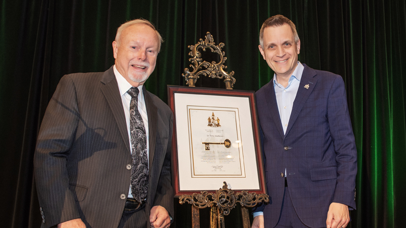 Sir Terry Matthews receives the Key to the City from Mark Sutcliffe during a presentation honouring Matthews at Brookstreet Hotel, April 7, 2026. Photo by Tia MacPherson for OBJ.