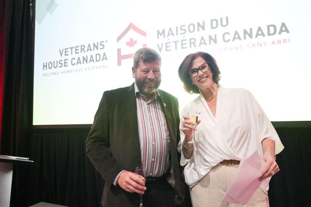 BGen (Ret’d) Alan Mulawyshyn (Executive Director, Veterans’ House Canada) and J’Lyn Nye (member of the VHC Board of Directors and emcee for the evening), prepare to join the toast during Veterans’ House Canada’s Andy Carswell Building 5th Anniversary celebration at the Canadian Aviation and Space Museum. Photo by James Park.