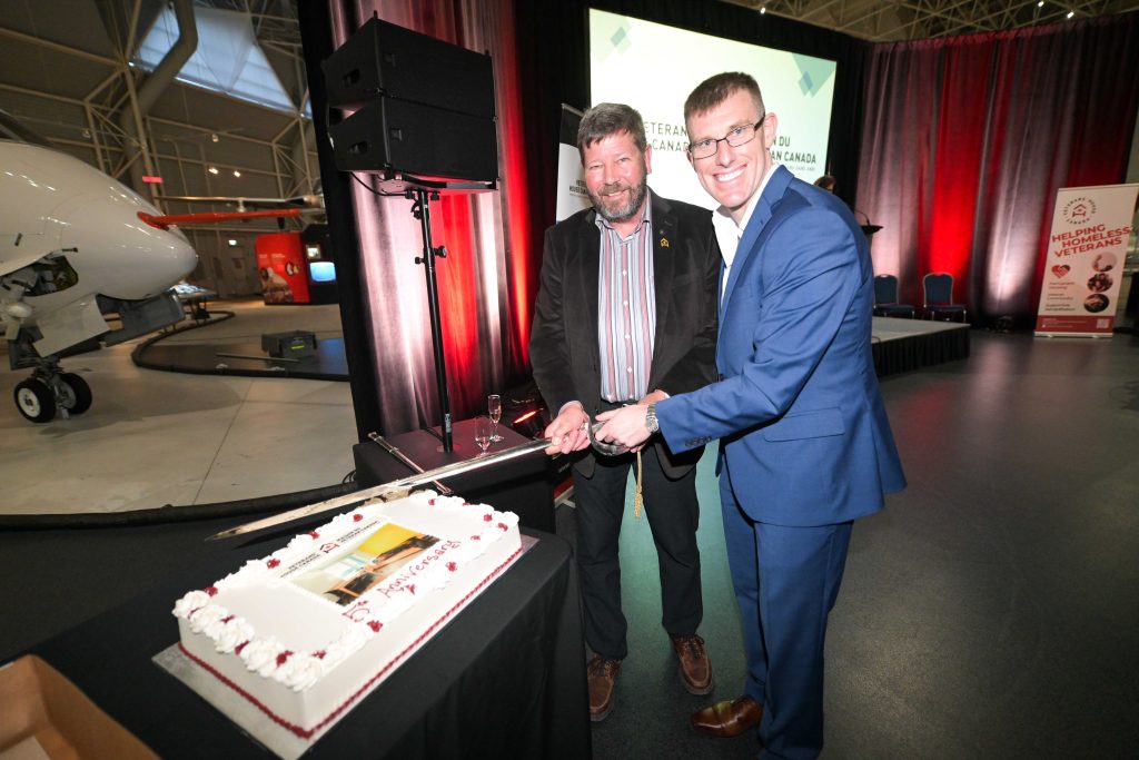 Brigadier-General (Ret’d) Alan Mulawyshyn (Executive Director, Veterans’ House Canada) and Major Colin Carswell (Canso Investment Counsel Ltd.) cutting the anniversary cake at the Canadian Aviation and Space Museum, May 28, 2026.