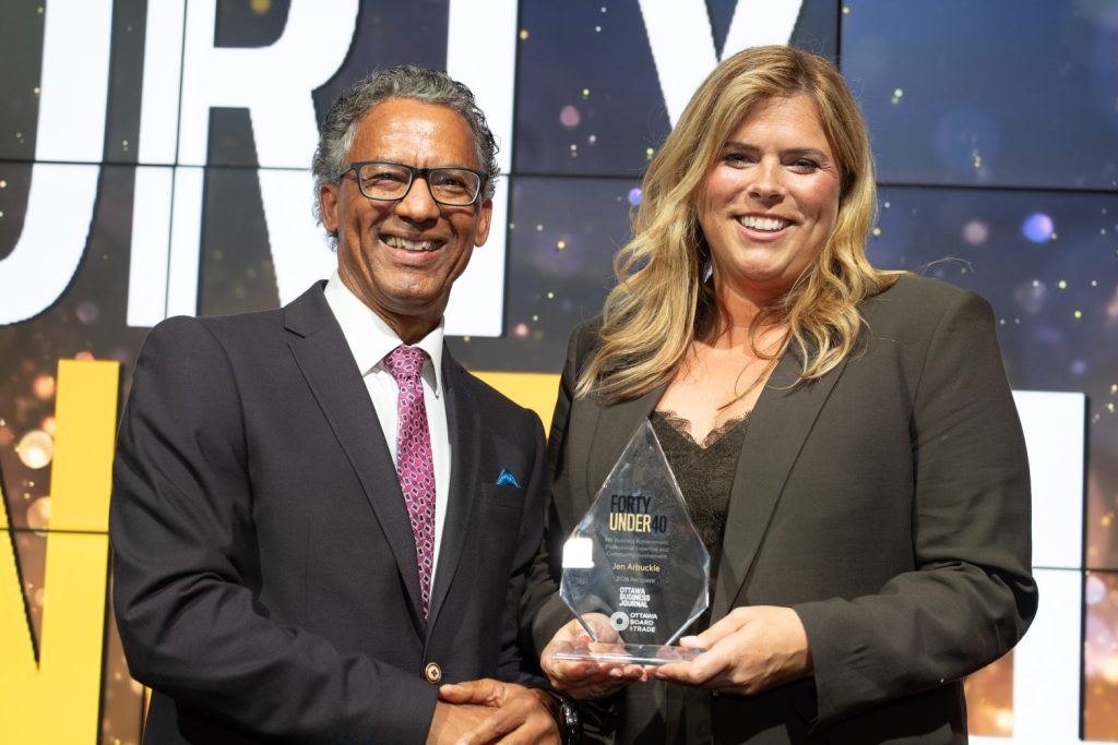 Awards sponsor Gregory Richards (Telfer Executive MBA) presents an award to Jennifer Arbuckle (Metcalfe Realty Company Limited) at the 2026 Forty Under 40 awards gala at Hilton Lac-Leamy, June 18, 2026. Photo by Mark Holleron for OBJ.