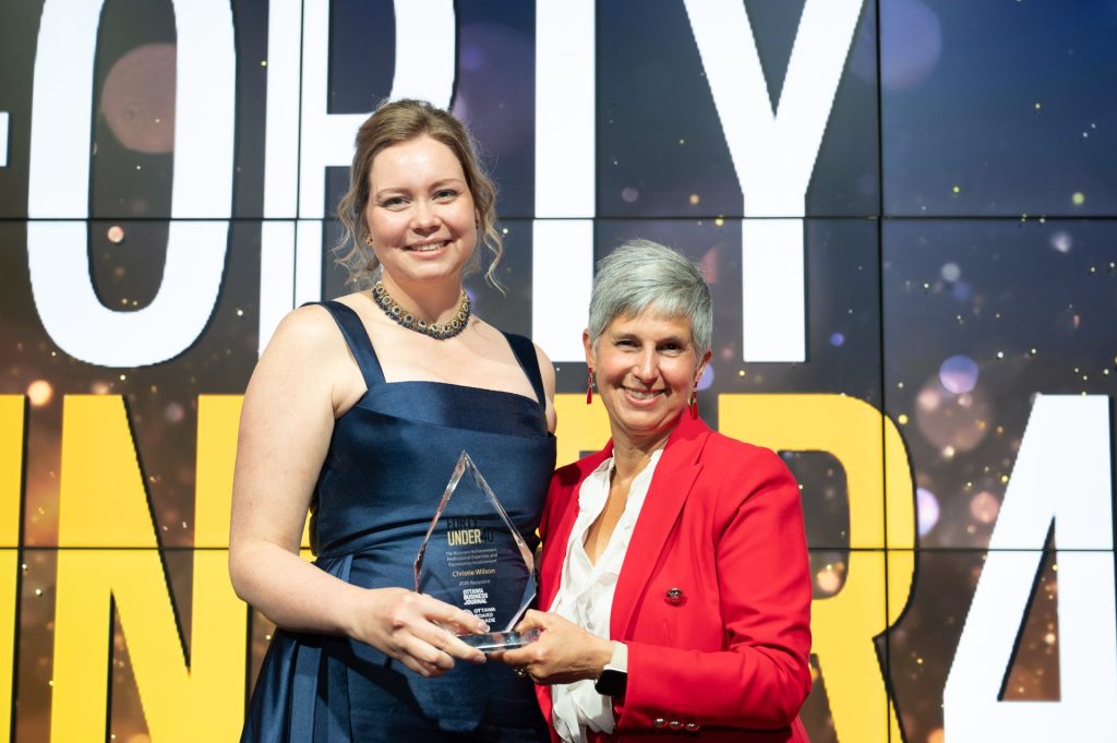Christie Wilson (International Workplace Group) accepts her award from awards sponsor Lise Sarazin at the 2026 Forty Under 40 awards gala at Hilton Lac-Leamy, June 18, 2026. Photo by Mark Holleron for OBJ.