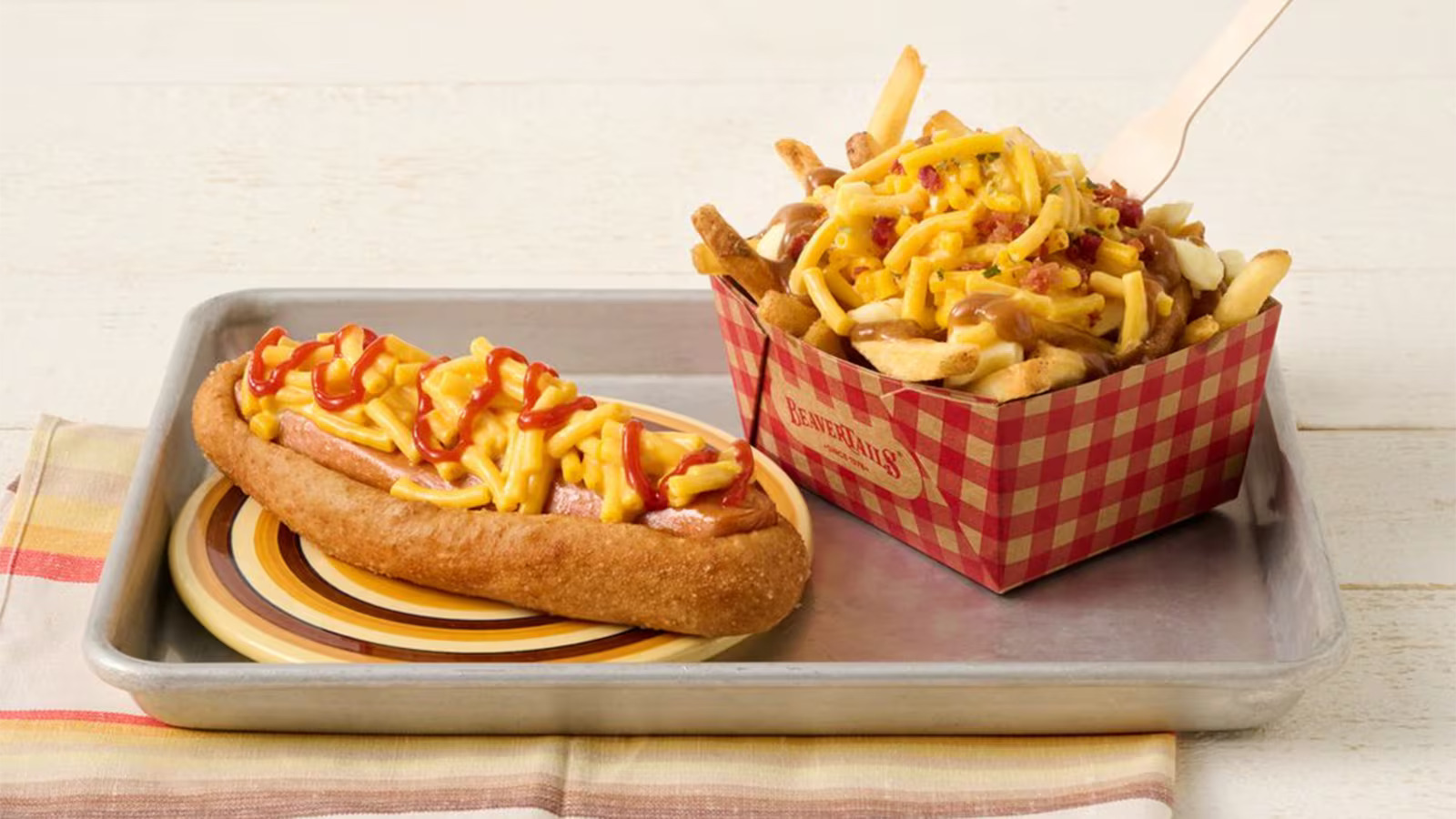 BeaverTails limited time menu items in collaboration with Kraft Dinner Canada: the KD Takeover BeaverDog and KD Takeover Poutine. Image credit: BeaverTails