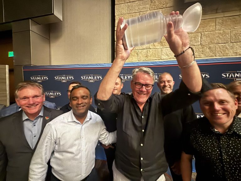 Peter Shier holding the Ottawa Senators' Stanley Award for best social impact and growth initiative. Photo from Peter Shier via LinkedIn.