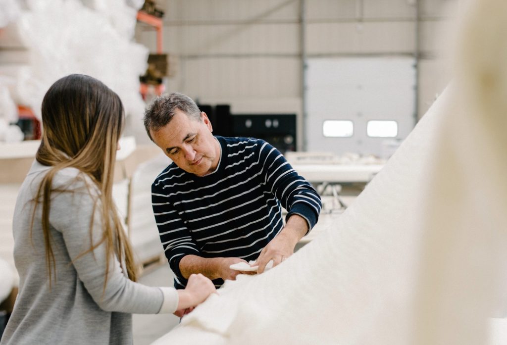 Obasan owner Jean Corriveau inspects certified organic wool in the company's Ottawa workshop, reflecting Obasan's commitment to exceptional materials and uncompromising quality.