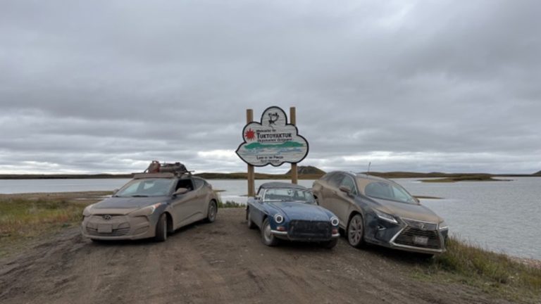Penny's MGB and his sons' cars in Tuk. Photo supplied.